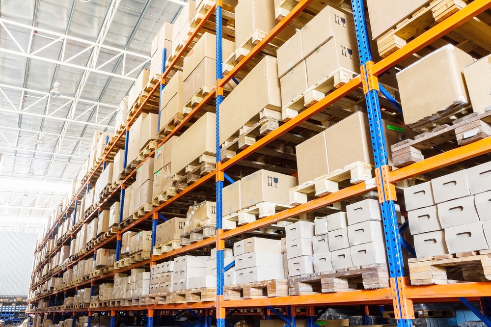 Rows of shelves with boxes in modern warehouse
